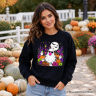 Colorful floral Halloween pumpkin sweatshirt featuring a bubblegum ghost haunted house design from OrnamentallyYou.