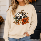 Cow pumpkin floral sweatshirt from OrnamentallyYou featuring autumn harvest design and western-inspired floral patterns.