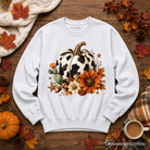 Cow pumpkin floral sweatshirt by OrnamentallyYou featuring autumn harvest and western-inspired design in a cozy sweatshirt style.