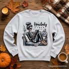 Ash gray Homebody Reading Skeleton sweatshirt by OrnamentallyYou, featuring a humorous lazy self-care design for introvert women.