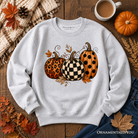 Leopard checkered pumpkin sweatshirt by OrnamentallyYou, cozy autumn fall sweater with fall-themed pattern and long sleeves.