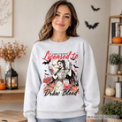 Gray Halloween nurse sweatshirt by OrnamentallyYou featuring spooky-themed blood draw graphic, perfect for spooky season.