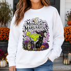 Black cat Halloween sweatshirt by OrnamentallyYou featuring spooky cocktail design for a witchy, festive fall look.