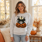 OrnamentallyYou Pumpkin Cherries Coquette Bow Sweatshirt with retro Halloween pumpkin and cherry design, perfect for fall autumn wear.
