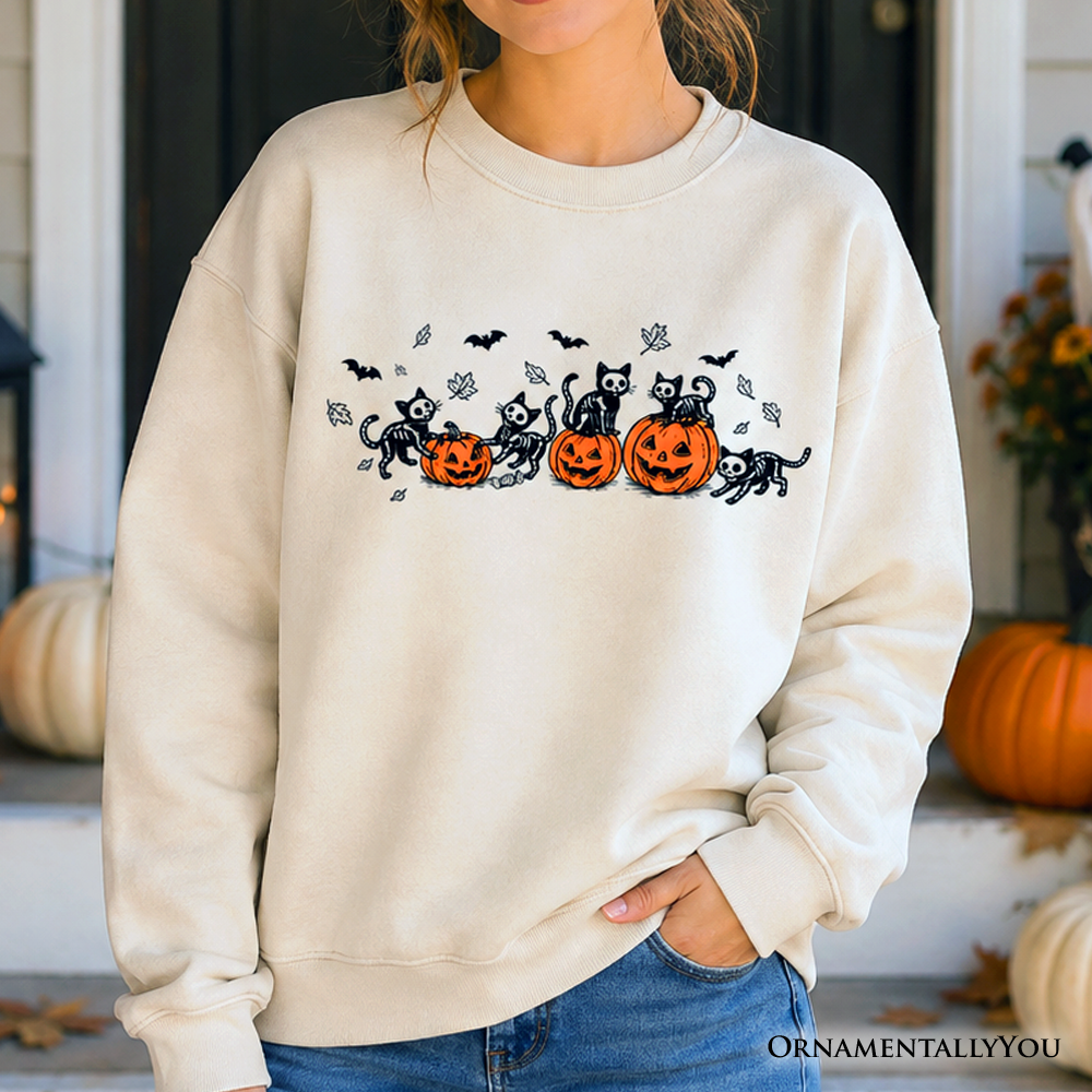 Black sweatshirt featuring skeleton cats and pumpkins, spooky Halloween design, by OrnamentallyYou, with festive, spooky imagery.