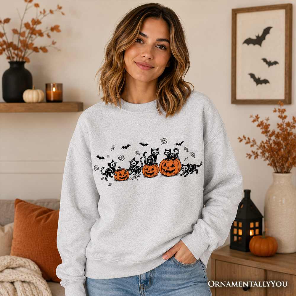 Black sweatshirt featuring spooky skeleton cats and pumpkins for Halloween, with a comfortable fit and festive fall design.