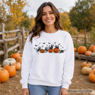 Black sweatshirt featuring skeleton cats and pumpkins, spooky Halloween design, from OrnamentallyYou, perfect for fall and Halloween.