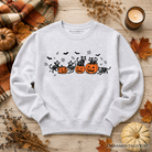 Black Halloween sweatshirt with skeleton cats and pumpkins design, featuring spooky black cat and pumpkin graphics on a cozy fabric.