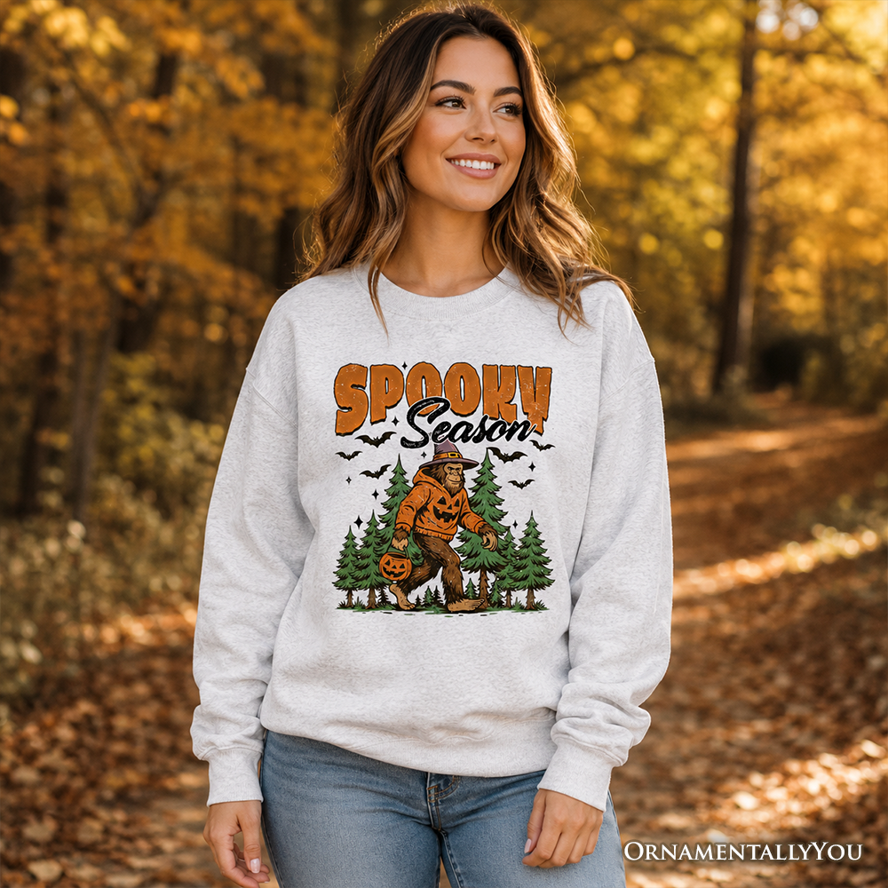 Spooky Season Bigfoot Halloween sweatshirt with Sasquatch and pumpkin design by OrnamentallyYou, cozy fall-themed sweater.