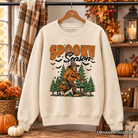 Spooky Season Bigfoot Halloween sweatshirt by OrnamentallyYou featuring a Sasquatch and pumpkin design on a cozy sweater.