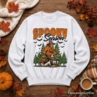 Spooky Season Bigfoot Halloween sweatshirt by OrnamentallyYou featuring Sasquatch and pumpkin design on a cozy sweater.