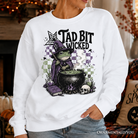 Ash gray Tad Bit Wicked Frog Witch Halloween sweatshirt by OrnamentallyYou featuring spooky cauldron and witch-themed design.