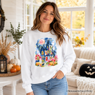 Watercolor Haunted House Halloween sweatshirt by OrnamentallyYou featuring colorful ghosts and pumpkins on a cozy sweater.