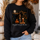 Black "I'm Just Here for the Boos" witch sweatshirt by OrnamentallyYou, featuring humorous Halloween party design and cozy fabric.
