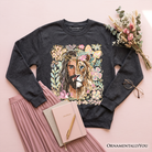 Black Lion of Judah Christian sweatshirt with floral Jesus design, featuring religious faith imagery and comfortable sweater style.