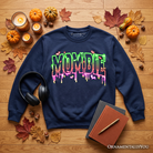 Black Mombie Halloween sweatshirt by OrnamentallyYou featuring spooky mummy graphics, perfect for funny mom costumes.