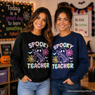 Black Spooky Teacher Neon Ghost Sweatshirt by OrnamentallyYou, retro Halloween sweater with ghost design for educators.