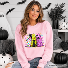 Colorful ghosts and black cats Halloween sweatshirt by OrnamentallyYou, featuring neon spooky season design on a Carolina blue background.