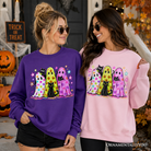 Colorful ghosts and black cats Halloween sweatshirt by OrnamentallyYou, featuring neon spooky season design on a Carolina blue background.