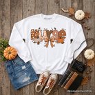 Nurse Coquette Autumn Sweatshirt by OrnamentallyYou featuring cozy fall pumpkin design, perfect for healthcare heroes.