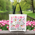 Black floral canvas tote bag featuring a humorous goose design from OrnamentallyYou, perfect for casual shopping and gifting.