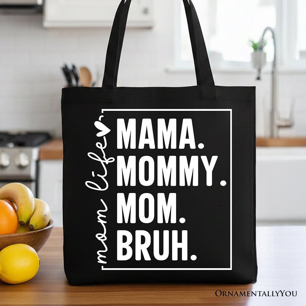 Black canvas tote bag by OrnamentallyYou with humorous "Mom's Life" print, perfect for stylish mothers and minimalist gift shoppers.