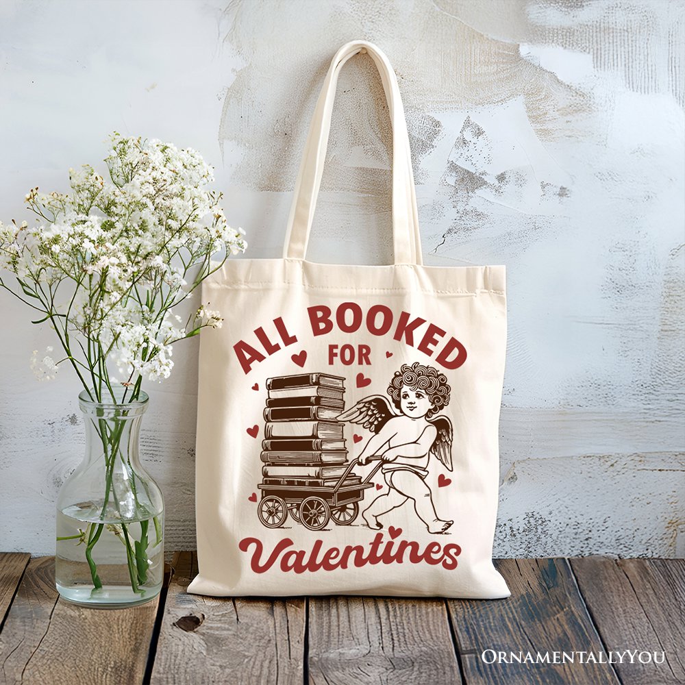 White canvas tote bag featuring a vintage funny "All Booked For Valentines" Cupid design, perfect for bookworms.