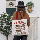 White canvas tote bag featuring a vintage Cupid design, ideal for bookworms and Valentine's Day gifts.