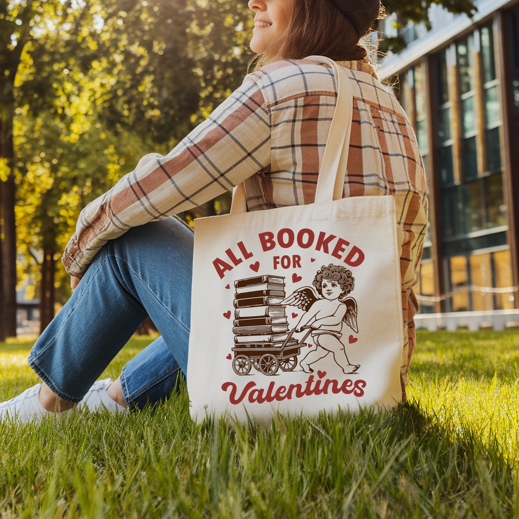 White canvas tote bag featuring "All Booked For Valentines" Cupid design, perfect for bookworms and vintage gift lovers.