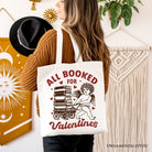 White canvas tote bag featuring "All Booked For Valentines" Cupid design by OrnamentallyYou, perfect for book lovers and vintage gift fans.