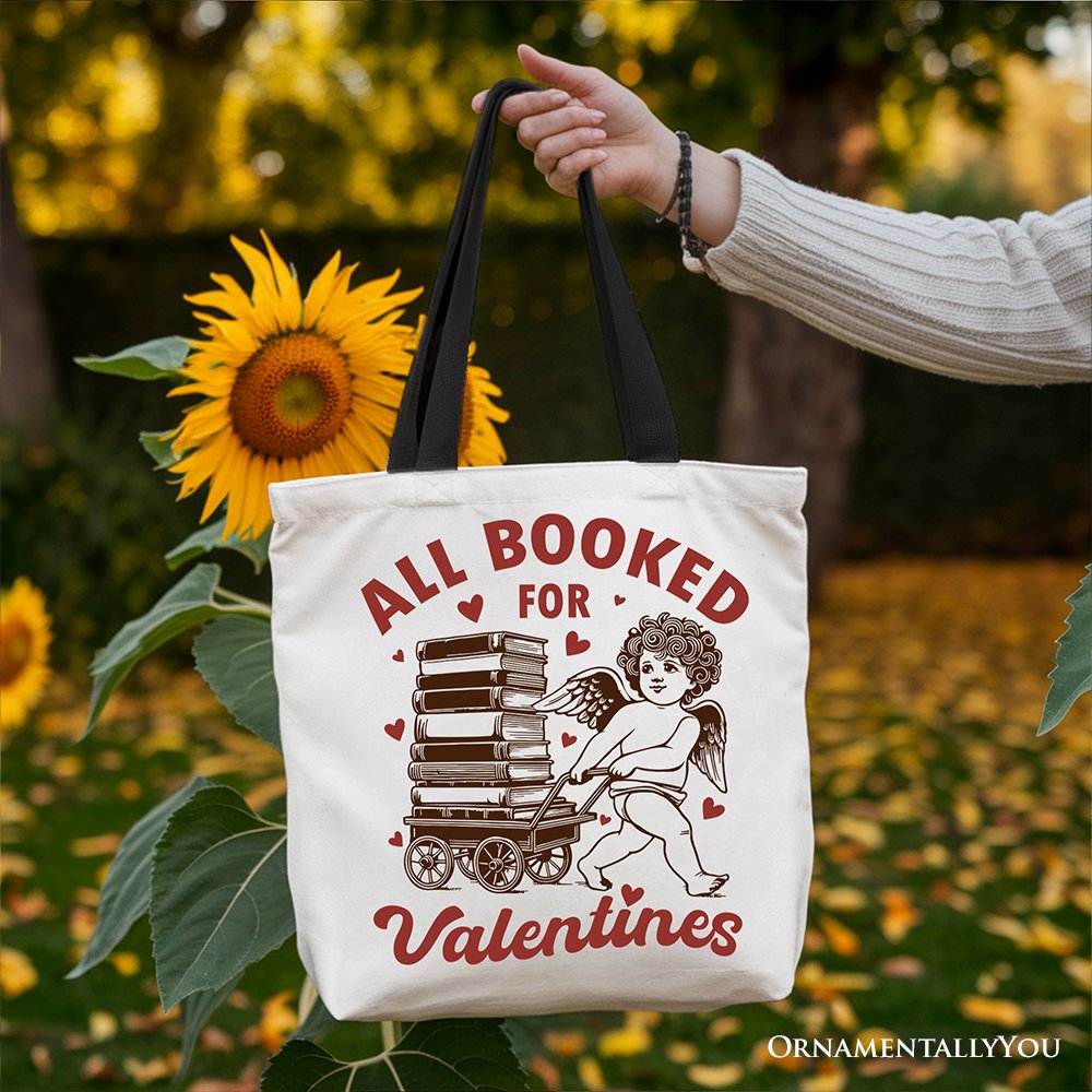 White canvas tote bag featuring a vintage "All Booked For Valentines" Cupid design, perfect for bookworm gift lovers.