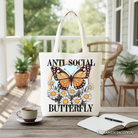 White canvas tote bag with anti-social butterfly graphic, stylish and quirky, perfect for independent women.