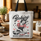 White tote bag featuring humorous "Baking Because Murder Is Wrong" slogan, perfect for kitchen or gift shopping.