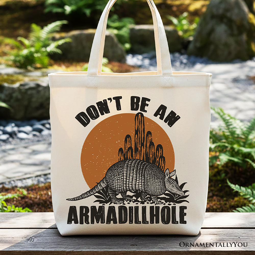 White canvas tote bag featuring humorous "Don’t Be An Armadillhole Armadillo" Western animal design, perfect for shopping or casual use.