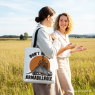 White canvas tote bag featuring a humorous armadillo design, ideal for casual shopping and Western animal gift enthusiasts.