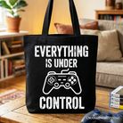 White Gamer Tote Bag by OrnamentallyYou featuring a funny video game controller design for gamers and shoppers.