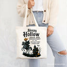 White canvas tote bag featuring the Headless Horseman from Sleepy Hollow Halloween theme, with retro Dead and Breakfast design by OrnamentallyYou.