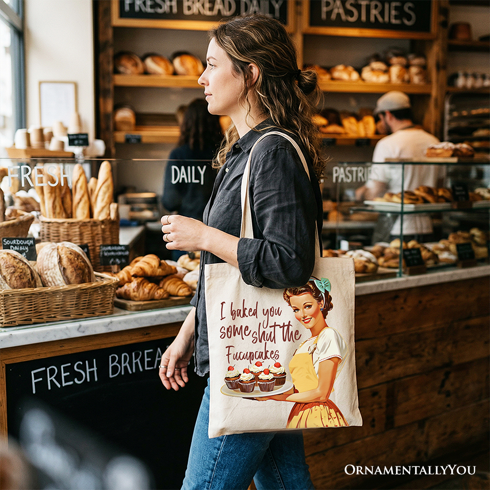 White tote bag from OrnamentallyYou with humorous "I Baked You Some Shut The Fucupcakes" design, perfect for fun bakers and kitchen gifts.
