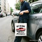 White tote bag by OrnamentallyYou featuring a humorous red truck design with "I Found A Deal On Marketplace" text, perfect for shoppers.