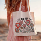 White canvas tote bag featuring floral affirmation design, ideal for inspiring women and boho motivational gift ideas.