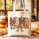 White Mama Coquette Autumn Tote Bag by OrnamentallyYou featuring cozy fall pumpkin designs, perfect for mothers.