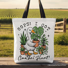 White canvas tote bag featuring humorous "Oops I Got Another Plant Goose" design, perfect for plant lovers and gardening humor fans.