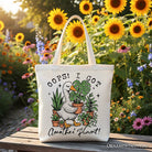 White canvas tote bag featuring humorous "Oops I Got Another Plant Goose" design, perfect for gardening humor fans.