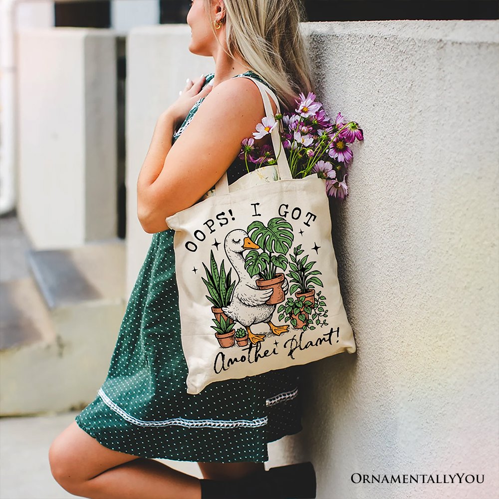 White canvas tote bag with humorous "Oops I Got Another Plant Goose" design, perfect for gardening enthusiasts.