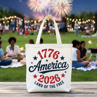 White patriotic canvas tote bag with 1776-2026 Land of the Free design, celebrating America's 250 years of independence.