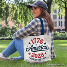 White patriotic canvas tote bag featuring "Land of the Free" and American flag design, celebrating 250 years of independence.