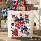 White canvas tote bag with patriotic boho strawberries bouquet patch, festive 4th of July design by OrnamentallyYou.