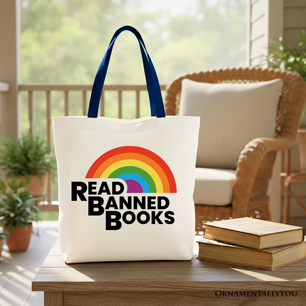 White Canvas Tote Bag by OrnamentallyYou featuring a rainbow design with "Read Banned Books" for book lovers and shoppers.