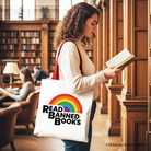 White canvas tote bag by OrnamentallyYou with rainbow read-banned books design, perfect for book lovers and shoppers.