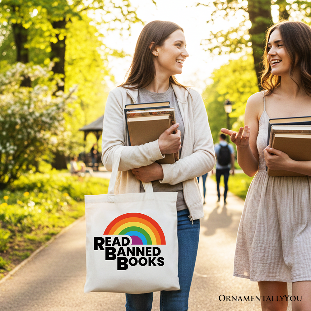 White canvas tote bag by OrnamentallyYou featuring a rainbow design and "Read Banned Books" message, perfect for book lovers.